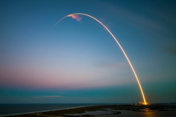 Rocket launch arcs over the ocean